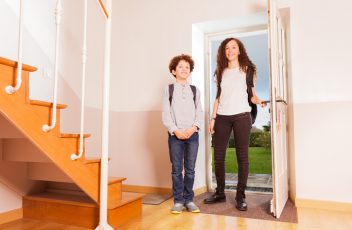 Brother and sister arriving home after school